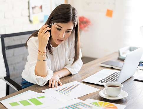 Young woman working on finances in home office