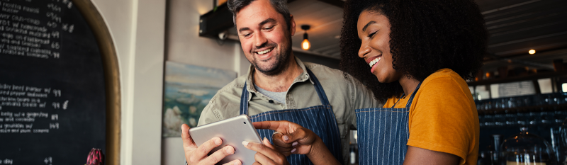 business owners looking at tablet